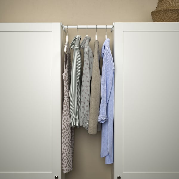 A closet with hanging shirts, using an adjustable HJÄLPA rail inside a platsa frame.