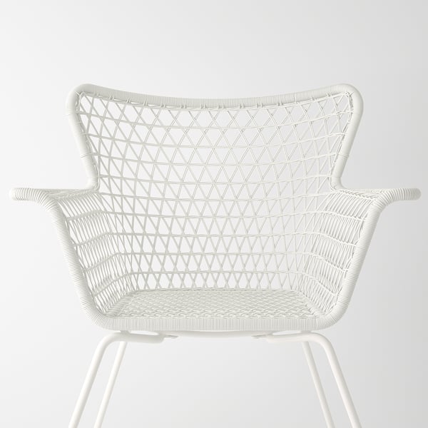 Modern white wicker chair, woven with geometric patterns, featuring a sturdy frame and comfortable armrests.