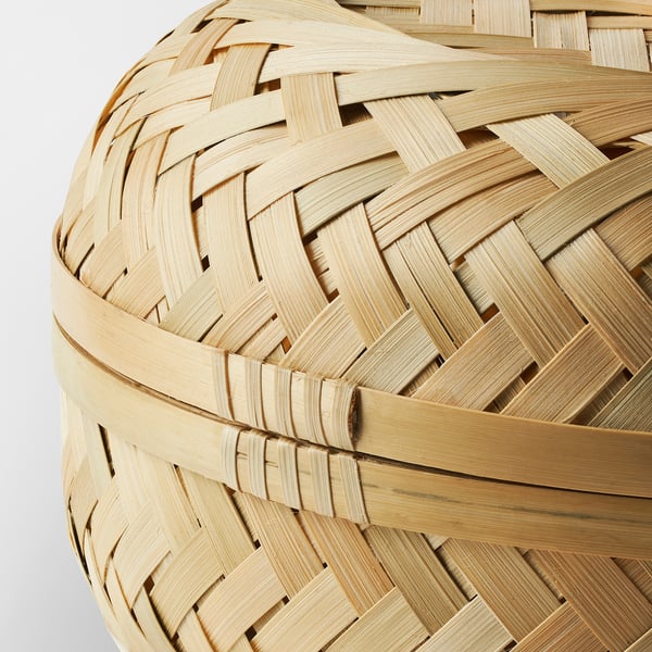 Handwoven bamboo basket, herringbone pattern, light brown, round shape.
