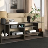 Dark brown HOLMERUD side table with shelves beside yellow sofa, blending modern design.