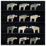 Wooden moose sculptures in black & white on shelves.