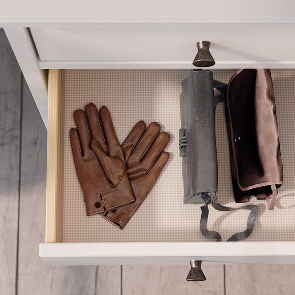 Brown leather gloves on white shelf with umbrella and coat.