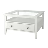 White IDANÄS glass-topped coffee table with wooden frame and drawer.