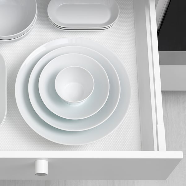 Nesting white porcelain bowls in drawer, demonstrating efficient storage and organization.