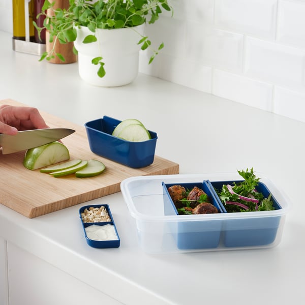 Preparing meal with sliced apple, organized IKEA 365+ container.
