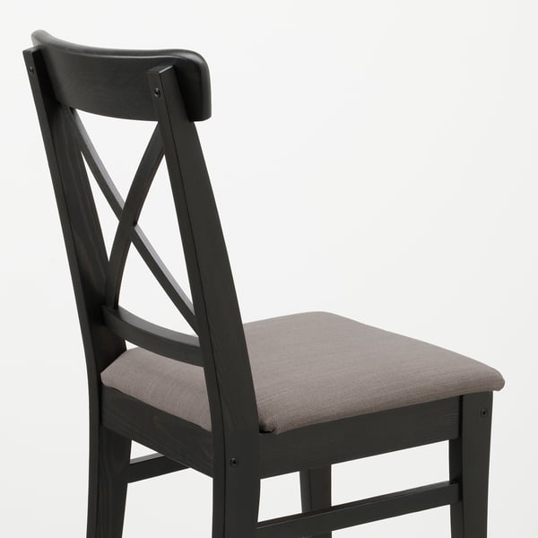 Dark wooden chair with upholstered seat, showing sturdy craftsmanship and modern design.