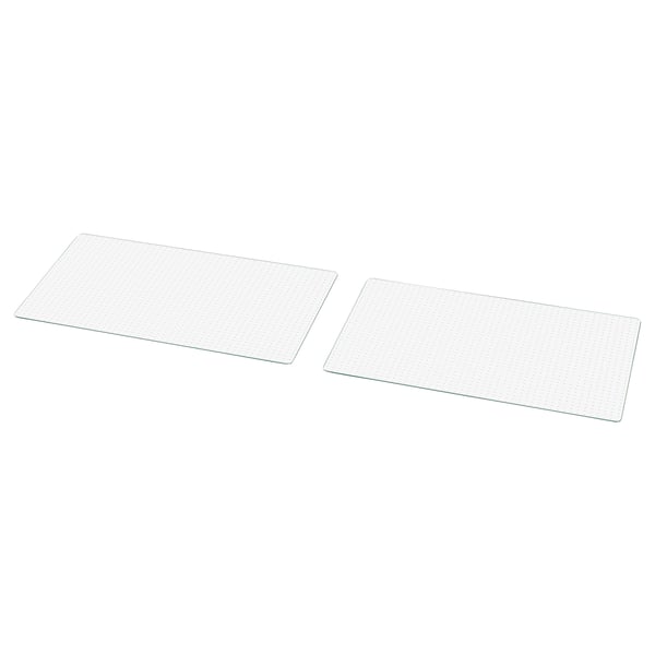 Two transparent glass plates, rectangular, with a grid design, lie flat side by side.