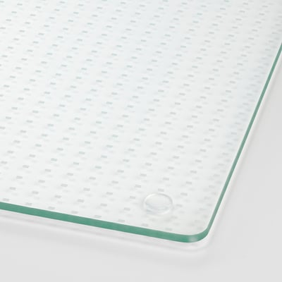 Two transparent glass plates, rectangular, with a grid design, lie flat side by side.