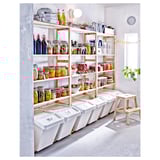 Well-organized pantry with white shelves holding colorful jars, and white bins below, made of solid pine.