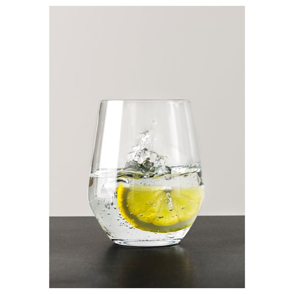 A clear, rounded glass with water and a lemon slice, suitable for red wine too.
