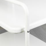 Close-up of white metal table edge with smooth finish and rivet detail.