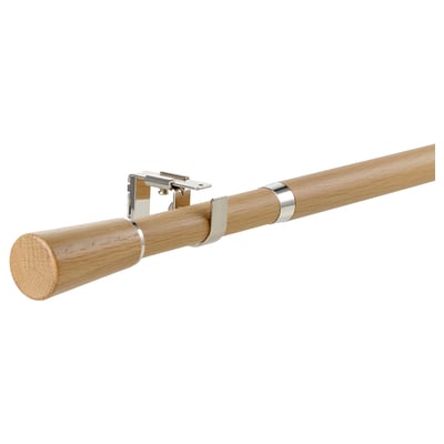 Wooden curtain rod, oak, with silver metal brackets, extending horizontally.