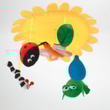 Colorful baby mobile with sun, bug, caterpillar, butterfly, and frog toys.