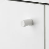 Modern white door handle on sleek cabinet.