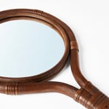Crafted rattan-framed mirror shows expert handiwork; curves elegantly, reflects light beautifully.