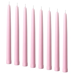 Nine pale pink KLOKHET candles in a row, cylindrical shape, made of stearin.