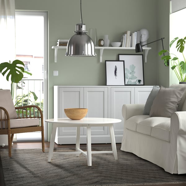 Modern living room with KNAPPHIRS rug, grey couch, and green walls.