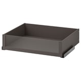 An empty, modern drawer named KOMPLEMENT in dark grey color with a sleek design. It a glass front for easy content viewing.