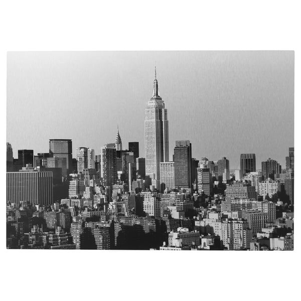 Black and white new york citys skyline, focusing on the empire state building, printed on a metallic surface.