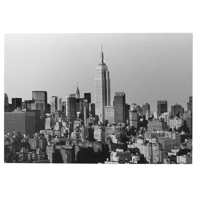 Black and white new york citys skyline, focusing on the empire state building, printed on a metallic surface.