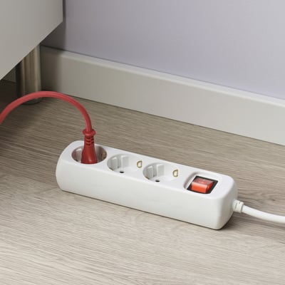 White extension socket with 3 outlets and a red power switch, providing additional power options.