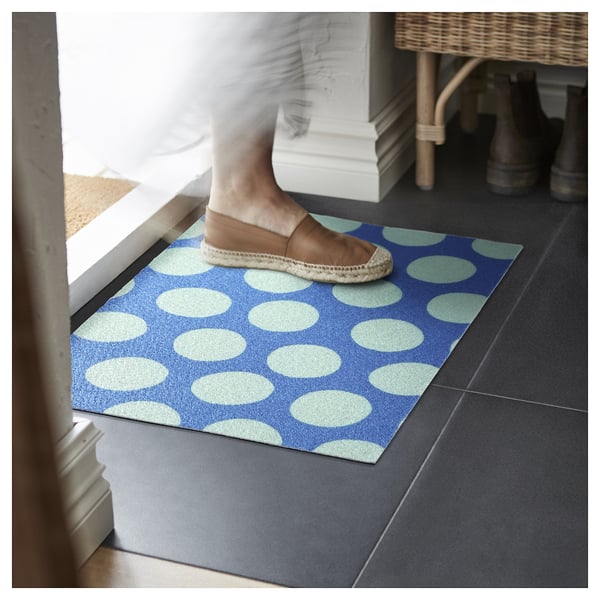 Person stepping on blue dotted mat.