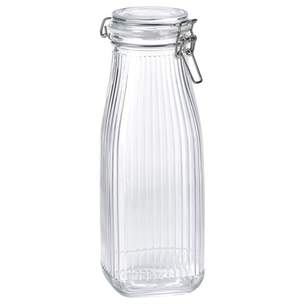 A KÖSSEBÄR glass jar with a metal lid, clear in color, ribbed design, bottle shape, with an airtight seal.