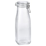 A KÖSSEBÄR glass jar with a metal lid, clear in color, ribbed design, bottle shape, with an airtight seal.