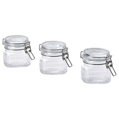 Three clear glass jars with silver lids and hinges, square-shaped, designed for storing food or small items.