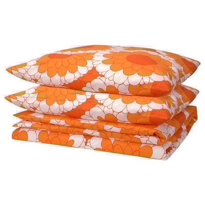 Three folded orange floral bedding sets with white flowers and green leaves. The pattern is retro, with a floral design popular from the 1970s.