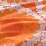 Bright orange flower pattern on soft cotton fabric. Vibrant, detailed design; high-quality, smooth texture. Modern take on 1970sétaient classic.