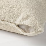 Light beige cushion cover with soft teddy-like pile; zip for easy washing.