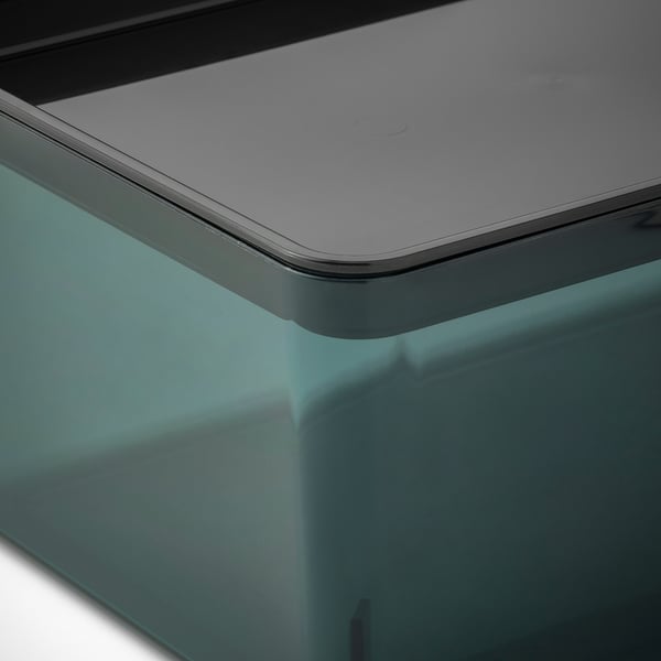 Close-up of a sleek, modern plastic box lid, smooth and reflective, with a recycled material base.