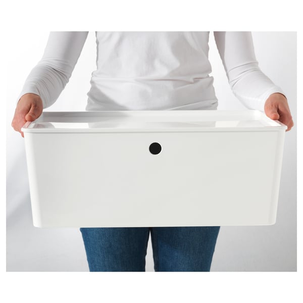 Person holding white storage box with lid.