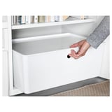 Hand placing lid on KUGGIS storage box, showcasing its dust protection feature.