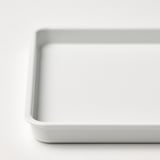 Close-up of a pristine, white plastic container with rounded edges, clean and undamaged, ideal for storage.