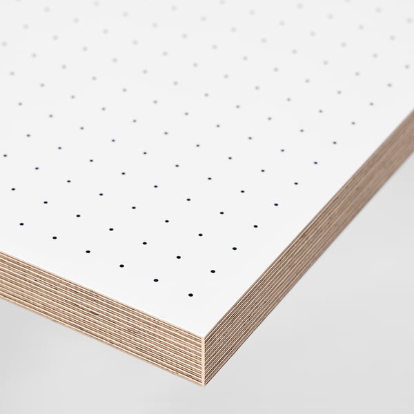 Stack of white sheets with gray dot grid patterns visible, showing high-quality, smooth paper with clean edges.