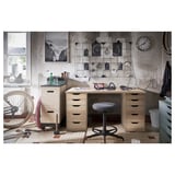 Industrial-themed office space featuring LAGKAPTEN light wood desk with drawers, stool, and decorative wall art.