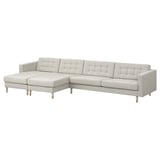A modern, light gray l-shaped couch with wooden legs, featuring a tufted backrest and removable armrests.