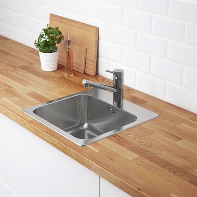 Stainless steel kitchen sink by ikea, square shape, single bowl with drainage area, shiny silver color, and modern design.