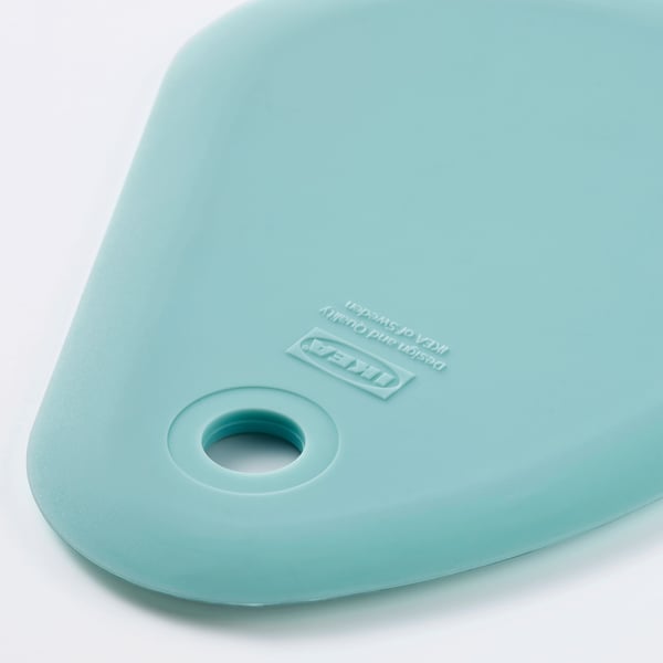 Light blue silicone spatula with smooth surface, ikea branding, and small hole.