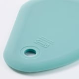 Light blue silicone spatula with smooth surface, ikea branding, and small hole.