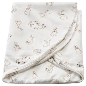 This image shows a white baby blanket with beige rabbit prints, featuring soft, sustainable cotton material.