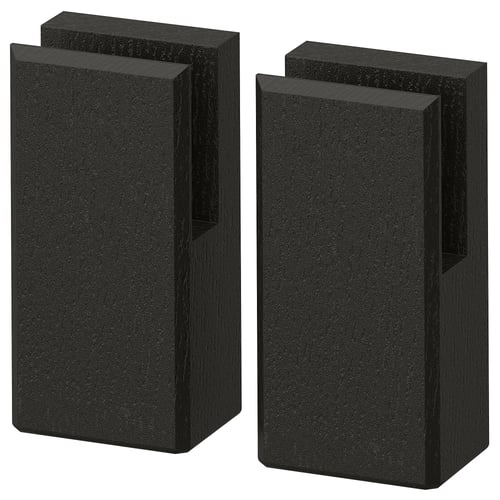 Two tall black rectangular wooden blocks, one slightly angled, on a white background.