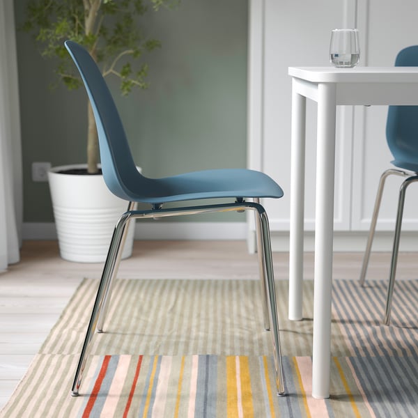 Chromed metal base chair, blue seat shell, stackable and flexible design, suitable for indoor use.