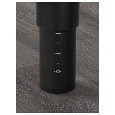 Black adjustable table leg on dark wooden floor; marked measurements from 60 to 90 cm.
