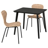 A LISABO dining set with a black table and wicker chairs.