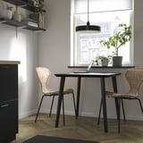 Modern workspace with LISABO table, chairs, shelf, and large window with blinds.
