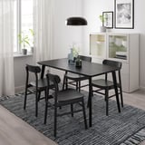 Black LISABO dining set with rectangular table and four chairs, minimalist white room.