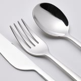 Polished cutlery set: includes knife, fork, and spoon. Stainless steel, shiny finish, smooth handles.